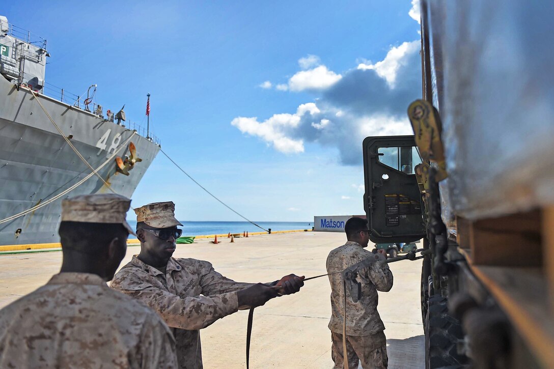U.S. Marines ready Humvees and 7-ton trucks at Saipan Harbor, Aug. 9, 2015, to move supplies to community centers in affected regions during disaster relief efforts after Typhoon Soudelor made landfall in Saipan.