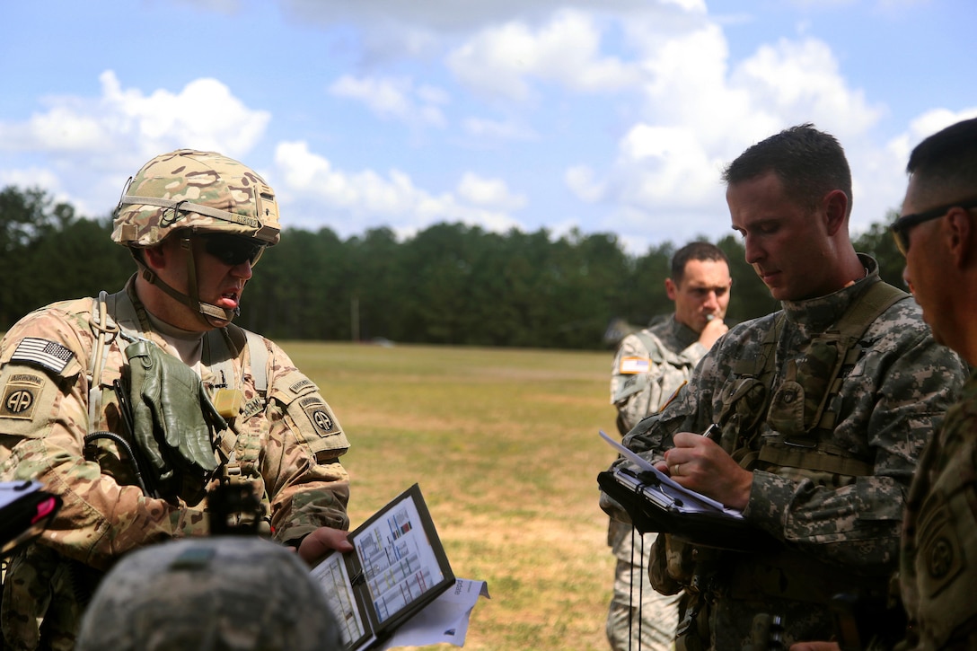 Army Lt. Col. Travis McIntosh briefs paratroopers before an air assault mission, Fort Bragg, N.C., Aug. 4, 2015. McIntosh commands the 82nd Airborne Division's 2nd Assault Helicopter Battalion, 82nd Combat Aviation Brigade. The paratroopers are assigned to the 82nd Airborne Division's 1st Battalion, 508th Parachute infantry Regiment, 3rd Brigade Combat Team. The training helped to increase the unit’s interoperability between ground and aviation units.
