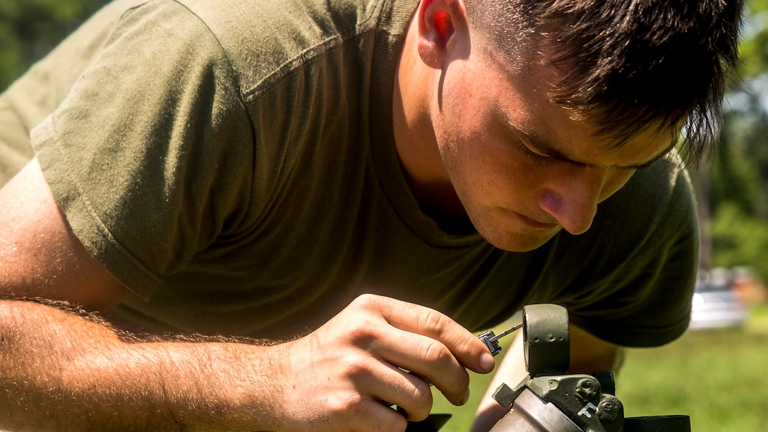 Private First Class Shawn Benoit, a mortarman with 1st Battalion, 8th Marine Regiment adjusts the sight on the M224 60 mm Mortar Lightweight Company Mortar System during a 10-day long mortar course under the direction of the Division Combat Skills Center at Marine Corps Base Camp Lejeune, North Carolina, Aug. 10, 2015. The course began with classroom instruction over the weapons system in which they learned how to boresight, misfire procedures and deflection changes for elevation before the unit moves into live-fire.