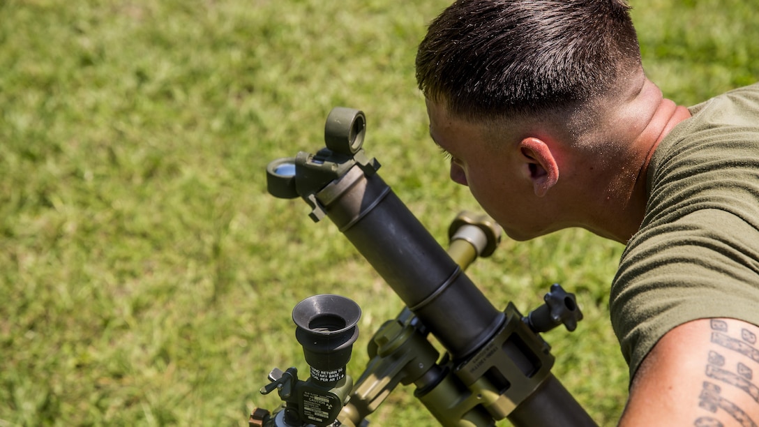 Lance Cpl. Dale Dibble, a mortarman with 1st Battalion, 8th Marine Regiment looks through the sight on the M224 60 mm Mortar Lightweight Company Mortar System during a 10-day long 60 mm Mortar Lightweight Company Mortar System course under the direction of the Division Combat Skills Center at Marine Corps Base Camp Lejeune, North Carolina, Aug. 10, 2015. The course began with classroom instruction over the weapons system in which they learned how to boresight, misfire procedures and deflection changes for elevation before the unit moves into live-fire.