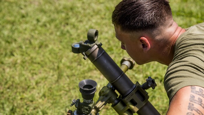 Lance Cpl. Dale Dibble, a mortarman with 1st Battalion, 8th Marine Regiment looks through the sight on the M224 60 mm Mortar Lightweight Company Mortar System during a 10-day long 60 mm Mortar Lightweight Company Mortar System course under the direction of the Division Combat Skills Center at Marine Corps Base Camp Lejeune, North Carolina, Aug. 10, 2015. The course began with classroom instruction over the weapons system in which they learned how to boresight, misfire procedures and deflection changes for elevation before the unit moves into live-fire.