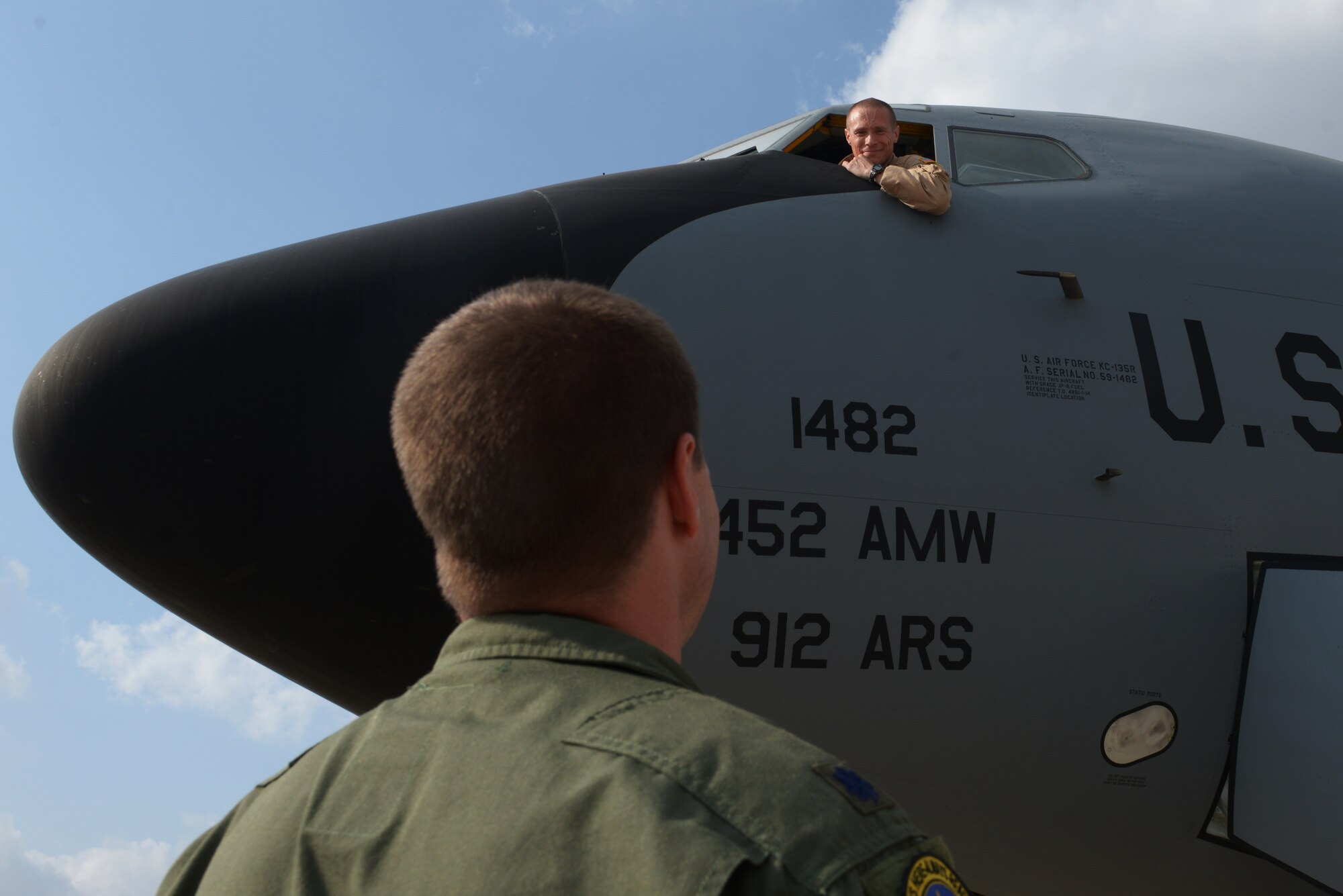 Lt. Col. Devin Shanks, 22nd Expeditionary Air Refueling Squadron operations officer, speaks to Lt. Col. Kyle Wilson, 39th Operations Support Squadron commander, from the window of a KC-135 Stratotanker Aug. 10, 2015, at Incirlik Air Base, Turkey. The U.S. Air Force deployed six F-16 Fighting Falcons from Aviano Air Base, Italy, support equipment and approximately 300 personnel to Incirlik AB in support of Operation Inherent Resolve. (U.S. Air Force photo by Senior Airman Krystal Ardrey/Released)