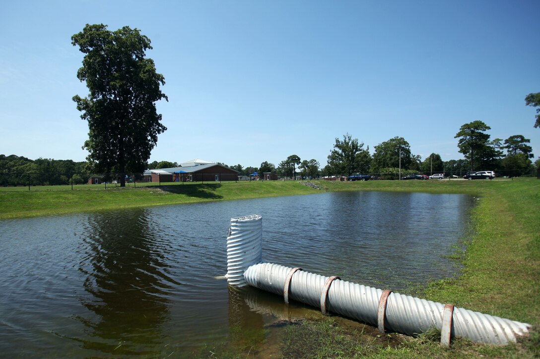 The Child Development Center wet detention basins are a part of Stormwater Control Measures at Marine Corps Air Station Cherry Point, North Carolina, July 31, 2015. SCM’s are designed to remove pollutants from the water by treating, slowing, and reducing stormwater runoff while also preventing flooding from occurring in heavily developed areas. 