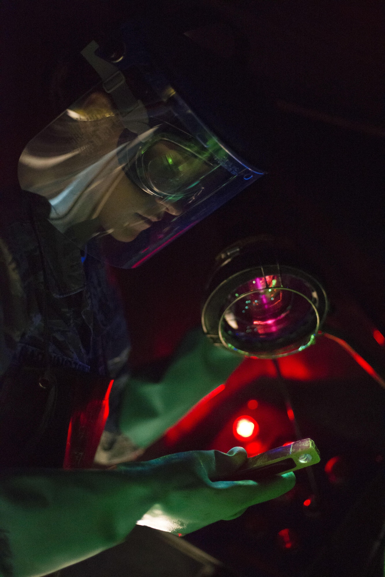 Airman 1st Class Danielle Harrington, a 2nd Maintenance Squadron nondestructive inspection apprentice, uses a black light to find cracks on a part at Barksdale Air Force Base, La., July 21, 2015. The black light and magnetic particle solution combine to enable technicians to evaluate defects in aircraft and equipment parts. (U.S. Air Force photo/Senior Airman Jannelle Dickey)