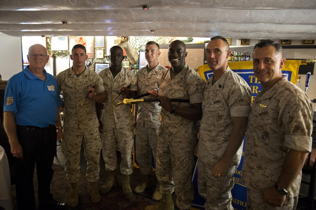 (From left to right) Earnie Giles, a president of the Miramar Semper Fidelis Rotary Foundation, poses with four honor graduates from the Marine Corps Air Station Miramar corporal’s course, Sgt. Maj. Patrick Kimble, sergeant major of 3rd Marine Aircraft Wing, and Maj. Gen. Michael Rocco, commanding general of 3rd MAW, after a Miramar Semper Fidelis Rotary Foundation meeting aboard MCAS Miramar, California, Aug. 6. The honor graduates received NCO swords in recognition of their hard work as noncommissioned officers. (U.S. Marine Corps photo by Cpl. Michael Thorn/Released)