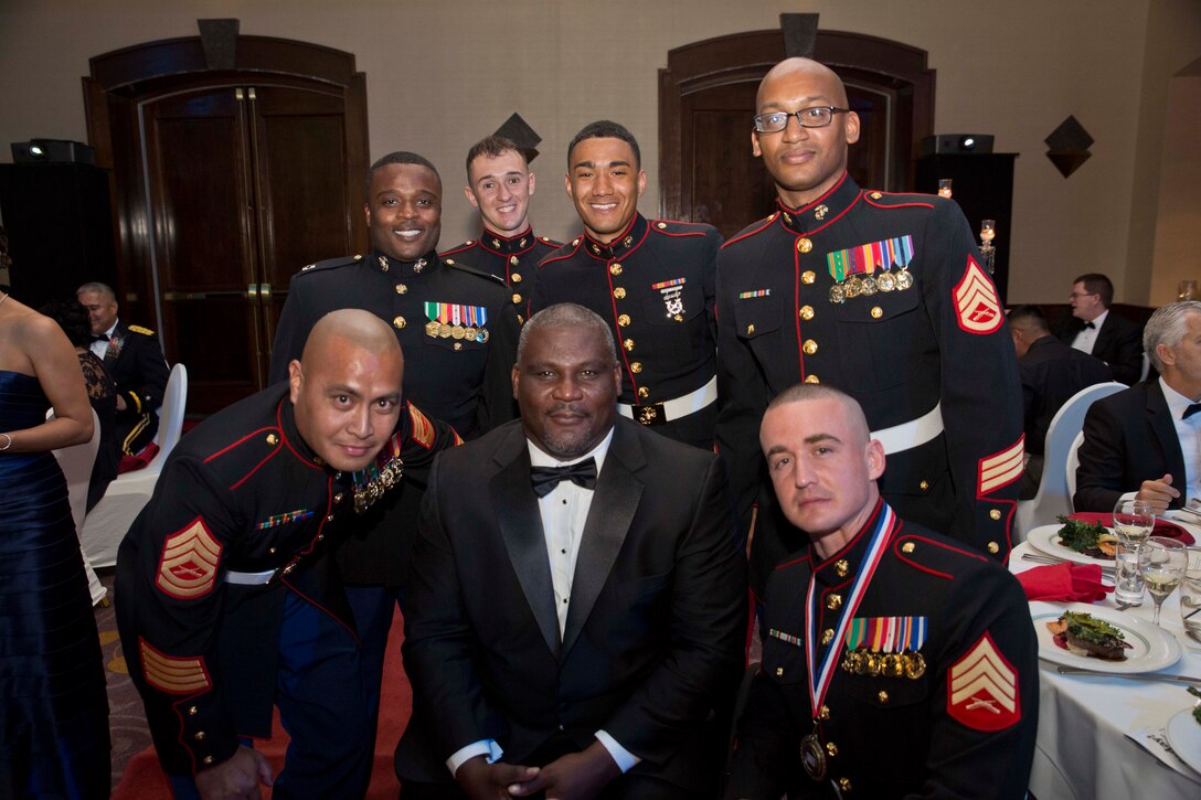 TUMON, Guam (March 9, 2015) -- Marines from Marine Corps Activity Guam take a photo with retired U.S. Army Col Gregory D. Gadson during the  United Service Organization Six Star Service Salute Event. The night consisted of a music performance by the USO Show Troupe, a speech from retired Army Col Gregory D. Gadson, and awards given to each branch of service for the USO Service member of the year. (U.S. Marine Corps photo by Lance Cpl. Jacob Snouffer/Released)