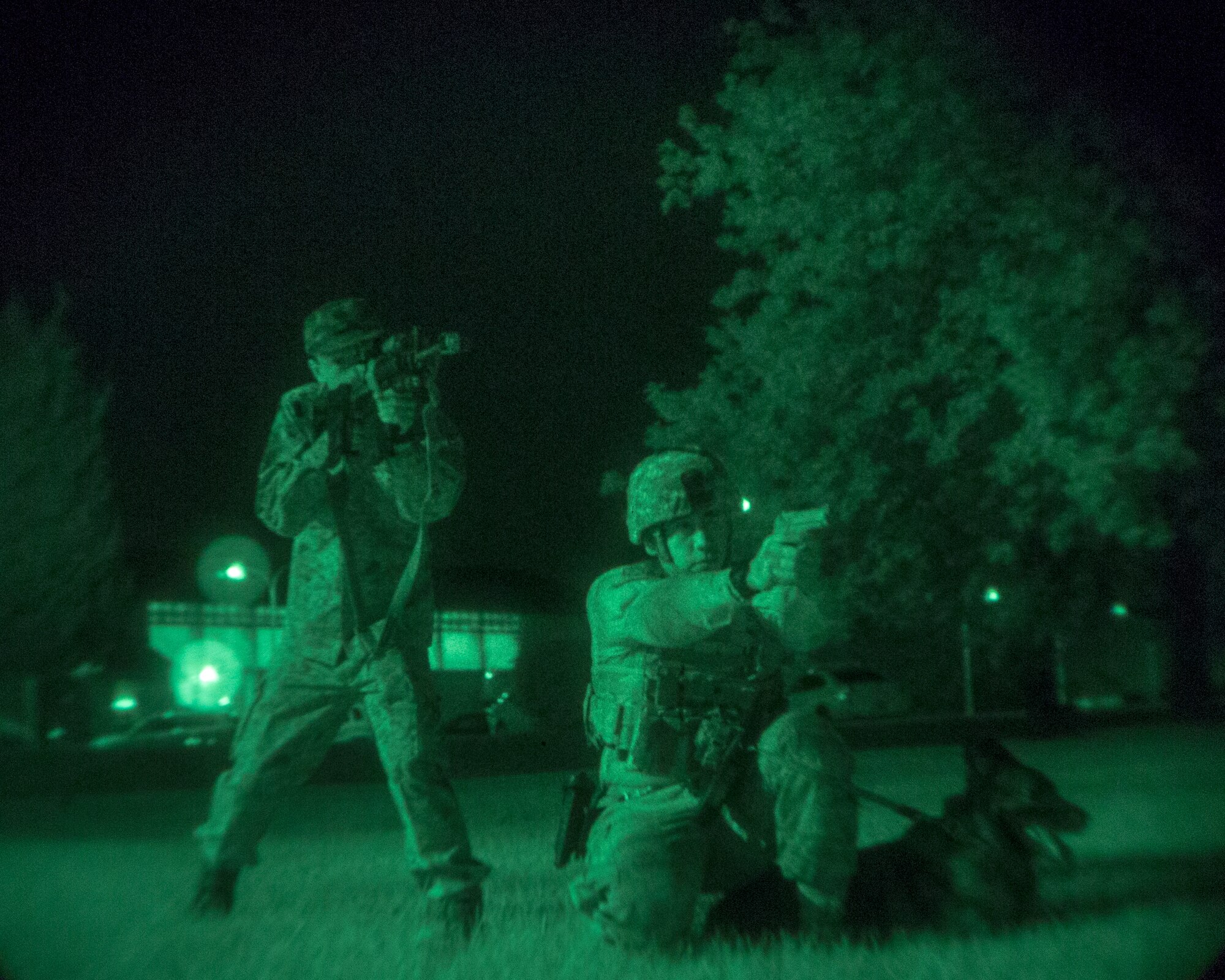 (Right to left) U.S. Air Force Senior Airman Jonathan Martinez, 374th Security Forces Squadron military working dog handler, and Japan Air Self-Defense Force Staff Sgt. Yoto Matsushita, Security Guard and Transportation Squadron, Iruma Air Base, aim simulated weapons during a joint training session at Yokota Air Base, Japan, Aug. 6, 2015. The 374th SFS provided various training sessions to the JASDF members. (U.S. Air Force photo by Osakabe Yasuo/Released) 