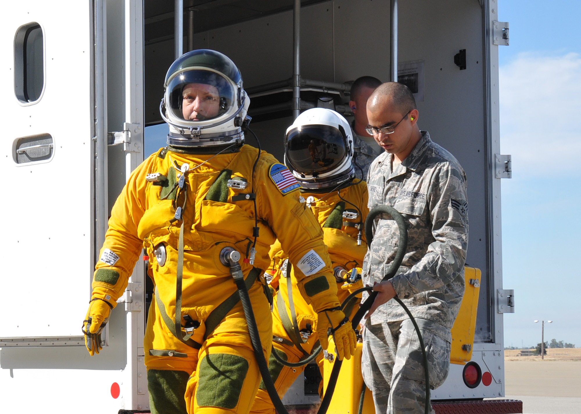Secretary of the Air Force Deborah Lee James (left), walks to a U-2 Dragon Lady as Senior Airman Aaron Saenz, 9th Physiological Support Squadron launch and recovery technician, carries high-altitude pressure suit auxiliary equipment at Beale Air Force Base, California, Aug. 11, 2015. The specialized pressure suit allows U-2 pilots to safely fly at altitudes reaching 70,000 feet. James visited Beale to receive a first-hand perspective of high-altitude intelligence, surveillance and reconnaissance from collection to dissemination. (U.S. Air Force photo by Senior Airman Dana J. Cable)