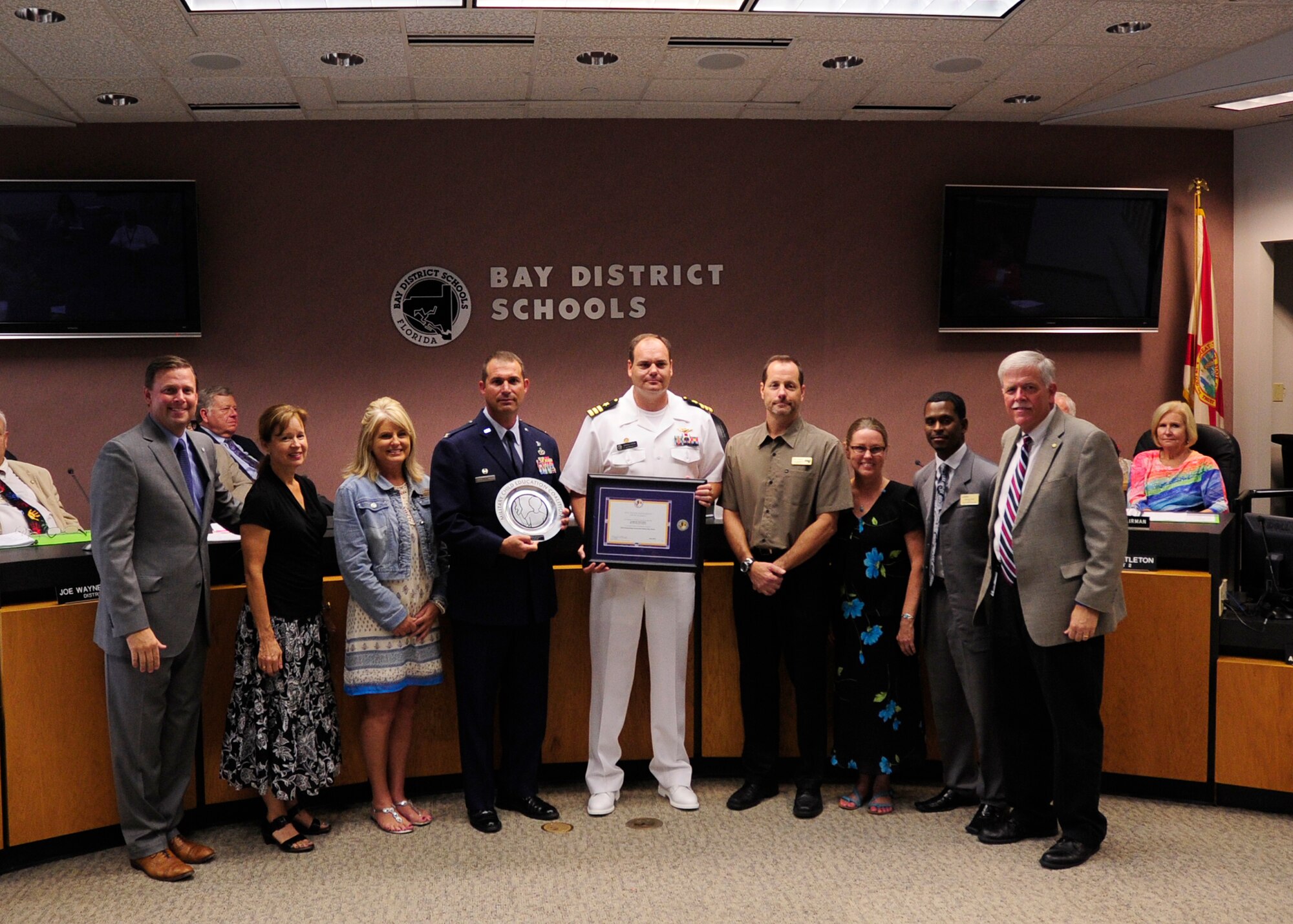 Colonel Ronald Pieri, 325th Mission Support Group commander and Team Tyndall members, accept  the Military Child Education Coalition-Pete Taylor Partnership Award Aug. 11 at a Bay District School Board meeting. The Military Child Education Coalition-Pete Taylor Partnership Award is an annual award that encourages and applauds the outstanding partnerships formed between military installations and school districts that serve military children. (U.S. Air Force photo by Airman 1st Class Solomon Cook/Released)