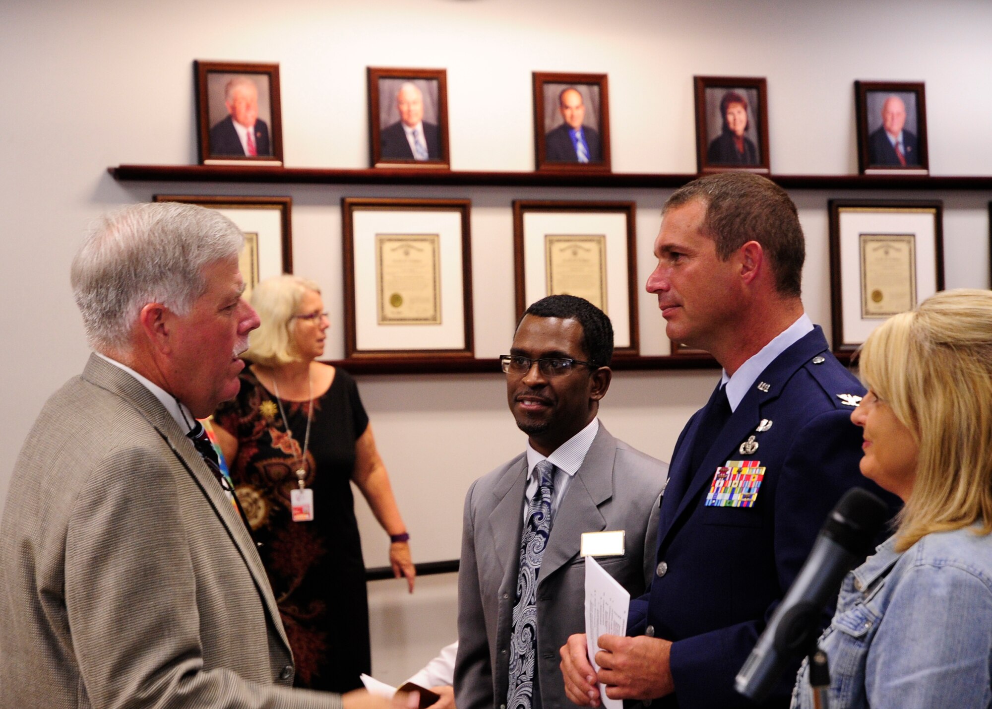 Colonel Ronald Pieri, 325th Mission Support Group commander and Team Tyndall members, speak with Bill Husfelt, Bay County School superintendent, prior to a meeting. In the meeting Tyndall, Naval Support Activity Panama City, and Bay District Schools received the Military Child Education Coalition-Pete Taylor Partnership Award. (U.S. Air Force photo by Airman 1st Class Solomon Cook/Released)