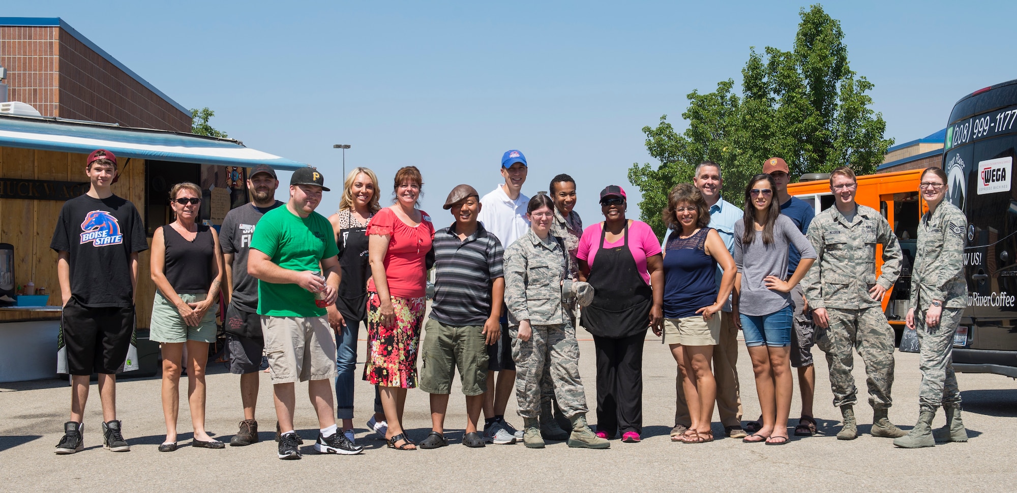 Food Truck Vendors pose with 366th Fighter Wing airmen at Gowen Field, Boise, Idaho, Aug. 4, 2015. The Army and Air Force Exchange Service and the 366th Force Support Squadron worked with food truck vendors to feed service members during the runway construction project at Mountain Home Air Force Base. (U.S. Air Force Photo by 2nd Lt. Kippun Sumner/RELEASED)