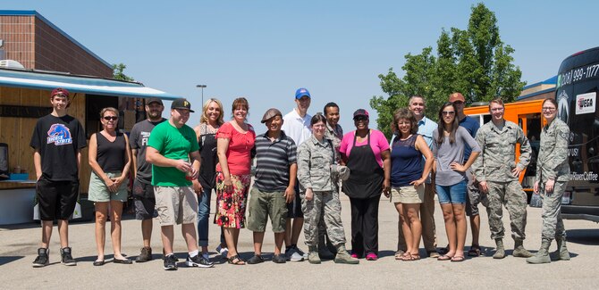 Food Truck Vendors pose with 366th Fighter Wing airmen at Gowen Field, Boise, Idaho, Aug. 4, 2015. The Army and Air Force Exchange Service and the 366th Force Support Squadron worked with food truck vendors to feed service members during the runway construction project at Mountain Home Air Force Base. (U.S. Air Force Photo by 2nd Lt. Kippun Sumner/RELEASED)