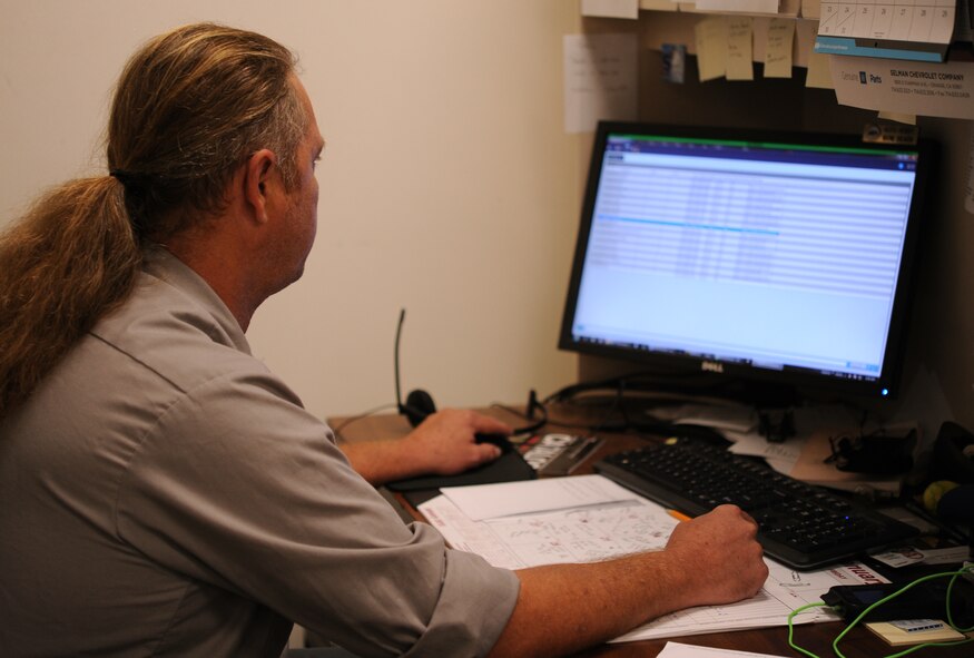 Wayne Shearon, a PAE vehicle inspector, reviews a list of all Vance vehicles with an installed Automated Information Module Fuel Management system, better known as AIM 2, Aug. 11, in Building 293. AIM 2 in an Air Force system designed to track fuel efficiency and more effectively manage vehicle fleets. From his computer Shearon can see how many miles a car has driven since its last fill up, see if the car is having any maintenance issues, and even see the speed at which the vehicle was driven. (U.S. Air Force photo Tech. Sgt. James Bolinger)