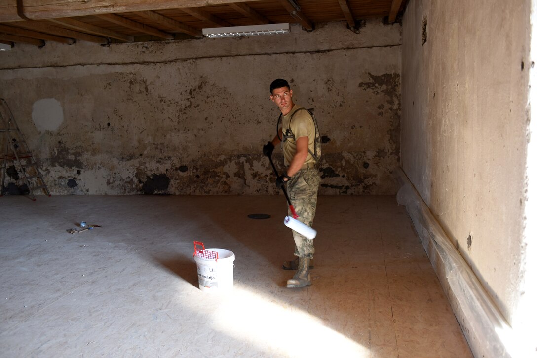 U.S. Air Force Staff Sgt. William Bryant, 140th Civil Engineer Squadron, Colorado Air National Guard (COANG), applies primer to a newly refinished wall during the restoration phase of converting a historically old building into a usable range center facility as part of a joint State Partnership Program in conjunction with the COANG at Pocek Range, near Postonja, Slovenia, July 21, 2015. The Slovenian Armed Forces (SAF) have previously visited COANG ranges to gain additional insight into overhauling the Pocek range to accommodate U.S., Slovenian and NATO countries in joint, multinational training and exercises. (U.S. Air National Guard photo by Senior Airman Michelle Y. Alvarez-Rea/Released)