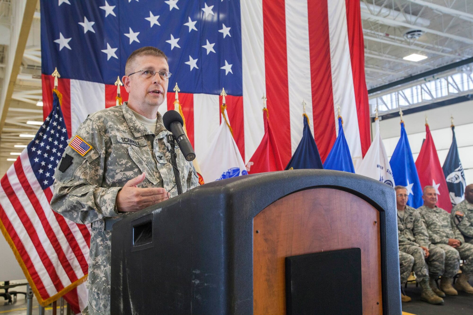 Col. John W. Scannell, State Aviation Officer, addresses dignitaries and Guard members during a ribbon cutting ceremony at the New Jersey Army National Guard's Army Aviation Support Facility, located at Joint Base McGuire-Dix-Lakehurst, N.J., Aug. 11, 2015. The 103,602 square-foot facility enhances the New Jersey National Guard's response to state and federal missions by providing the newest and most efficient aircraft maintenance and training support equipment. The facility includes 10 aircraft maintenance hangar bays, two unheated storage buildings and allied shops. (U.S. Air National Guard photo by Master Sgt. Mark C. Olsen/Released)