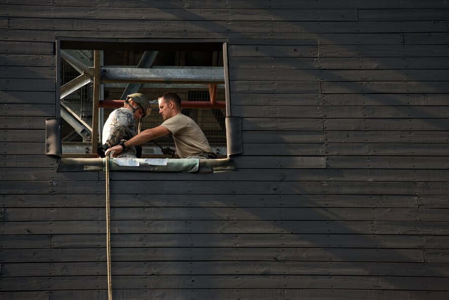U.S. Air Force Staff Sgt. Michael Kearns (right), 820th Base Defense Group rappel master, prepares Staff Sgt. Tyler Hodge, 820th COS communications technician, for a rappel Aug. 5, 2015, at Moody Air Force Base, Ga. Moody’s Rappel Tower Program provides Moody's base defenders rappel training to further their capabilities. (U.S. Air Force photo by Airman 1st Class Dillian Bamman/Released)
