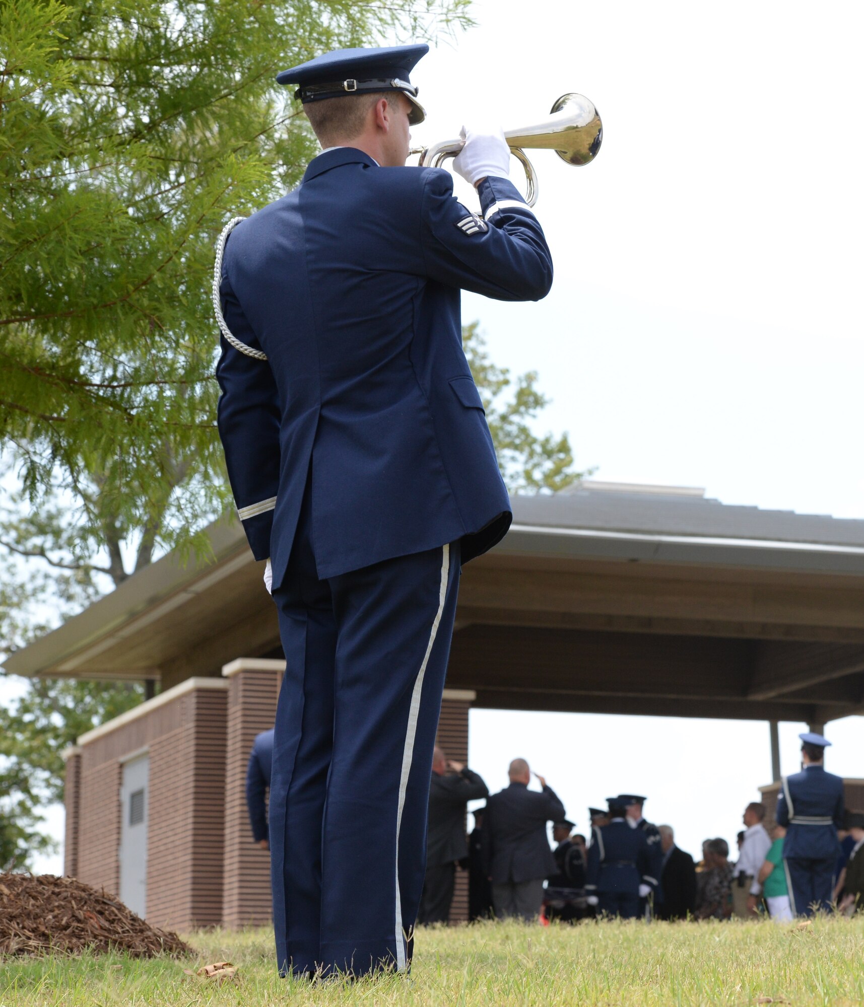 Senior Airman Justin Keller, Columbus Air Force Base Honor guardsman, plays Taps for a Missing in Action ceremony for Capt. Frederick Partridge Aug. 10 at the Mississippi Veterans Memorial Cemetery. A native of Sumner, Mississippi, Partridge served in both World War II and in Korea in his eight years of service until he was shot down the morning of Aug. 10, 1952. (U.S. Air Force photo/2nd Lt. Lauren Woods)
