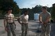 U.S. Air Force Staff Sgt. Michael Kearns (right), 820th Base Defense Group rappel master, demonstrates proper rappel form to Airman 1st Class Jeffrey Lewis (left), 822d Base Defense Squadron fire team member, and Staff Sgt. Daniel Centreras, 822d BDS fire team leader, during a rappel training session Aug. 5, 2015, at Moody Air Force Base, Ga. Kearns warned the defenders on how improper hand grip could lead to injuries. (U.S. Air Force photo by Airman 1st Class Dillian Bamman/Released)