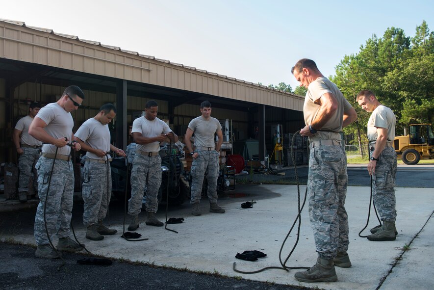 U.S. Air Force Staff Sgt. Michael Kearns, 820th Base Defense Group rappel master, briefs participants on harness preparations during a rappel training session Aug. 5, 2015, at Moody Air Force Base, Ga. The session served as an enhancement of the participants’ base defense capabilities. (U.S. Air Force photo by Airman 1st Class Dillian Bamman/Released)