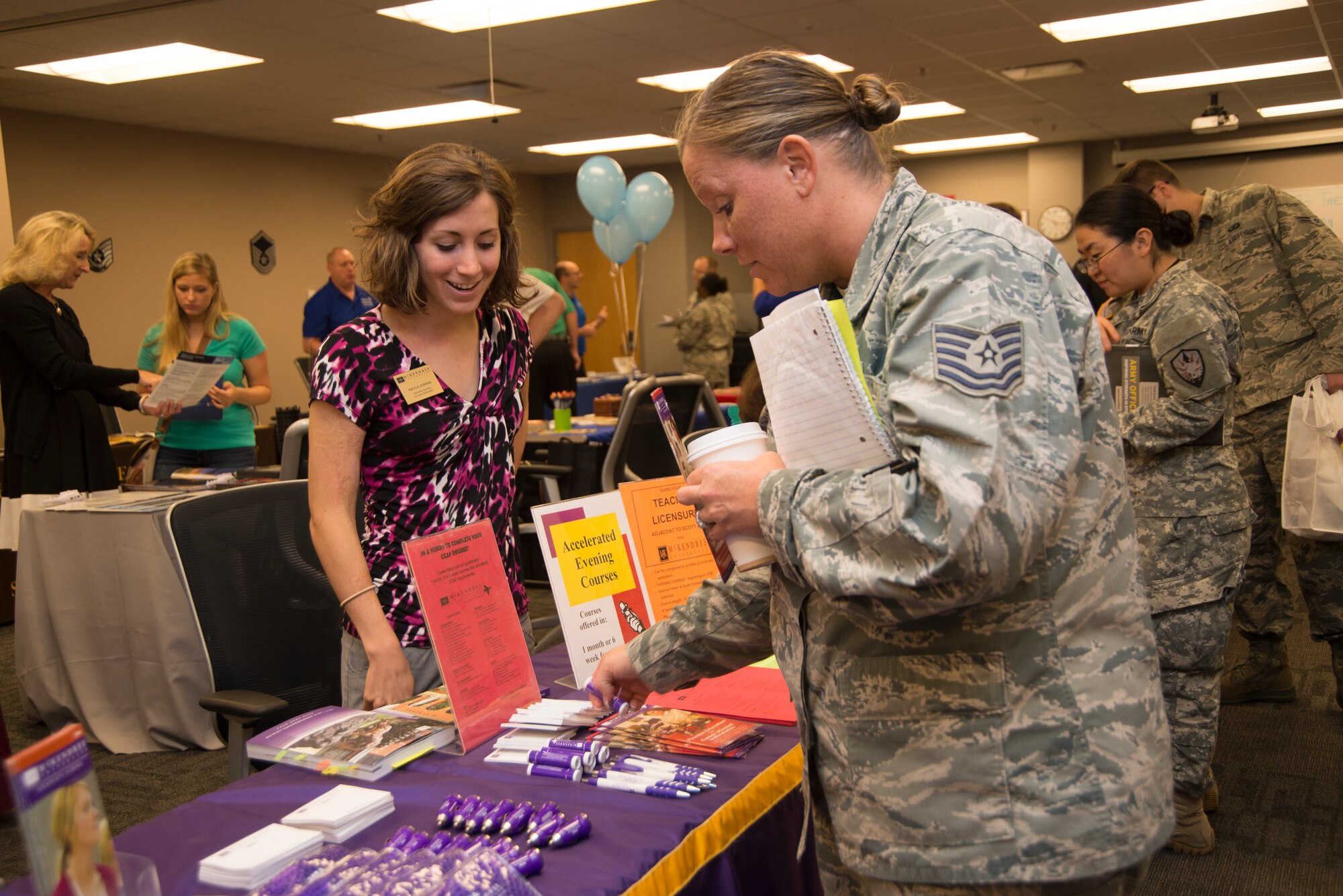 A technical sergeant gathers information about schools at the education fair August  5, 2015, at Scott Air Force Base, Illinois. The schools aim to provide an education plan for every individual regardless of age or time constraints. (U.S. Air Force photo/Airman 1st Class Melissa Estevez)