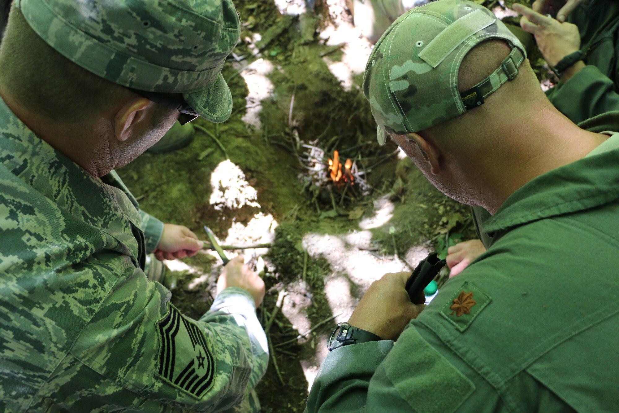 Members of the 164th Airlift Squadron perform ground survival training near Butler, Ohio, Aug. 1, 2014. The 113th Air Support Operations Squadron (ASOS), of the 181st Intelligence Wing, Terre Haute, IN., assisted the Ohio Air Guard aircrew with the training. Two members of the 113th ASOS Tactical Air Patrol Party (TACP) teamed up to share their expertise in this training. The aircrew members are required to stay current in survival tactics and procedures on both land and water.(U.S. Air National Guard Photo by Tech. Sgt. Joseph Harwood\Released)