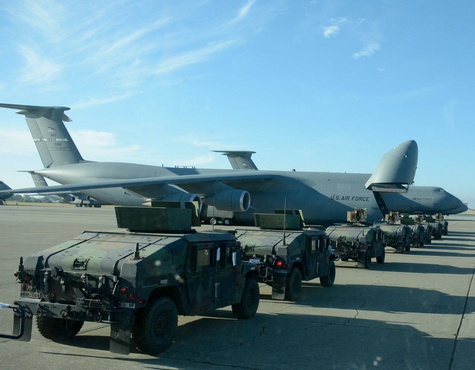 The California Army National Guard 49th Military Police Brigade trains with the 821st Contingency Response Squadron and the 22nd Airlift Squadron Aug. 7 at Travis Air Force Base, Calif. They jointly loaded nine Humvees and one expandable mobile command post vehicle onto a C-5M Super Galaxy to be transported to Moffett Federal Airfield as part of exercise Eagle Walk. (U.S. Air Force photo by Airman 1st Class Amber Carter)