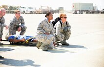 Airmen prepare to lift a simulated casualty strapped to a medical litter during a Major Accident Response Exercise at Malmstrom Air Force Base, Mont., August 10, 2015. Airmen of all ranks worked together to demonstrate Air Force response capabilities during a simulated natural disaster emergency. (U.S. Air Force photo/Airman 1st Class Magen M. Reeves)