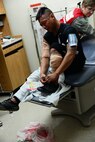 Airmen participate in a Major Accident Response Exercise at Malmstrom Air Force Base, Mont., on August 10, 2015. The exercise focused on evaluating several emergency response sections including patient care and management at the base medical facility. (U.S. Air Force photo/Airman 1st Class Magen M. Reeves)