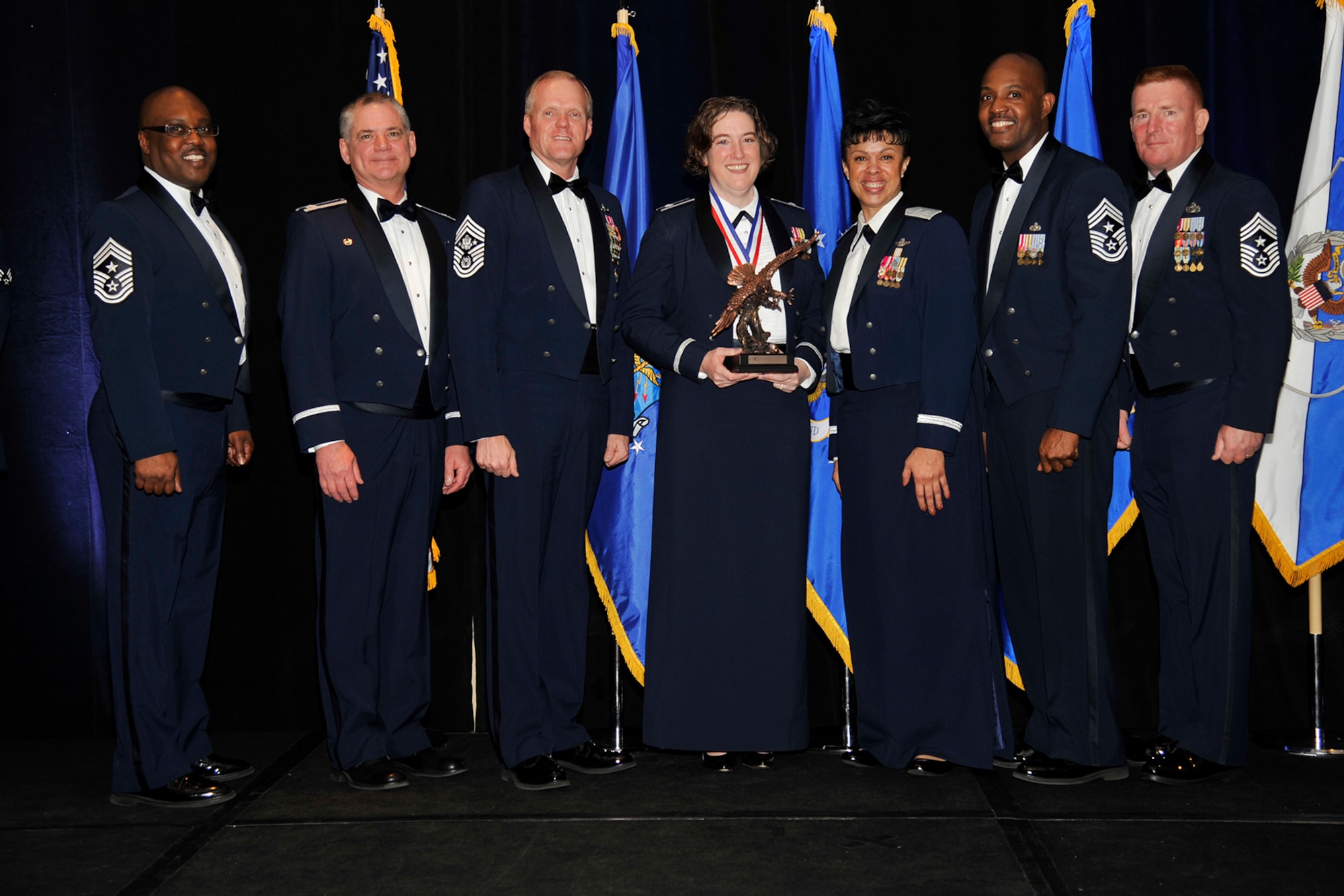 Lt. Col. Esther Weightman, center, received the 2014 Field Grade Officer of the Year award at the 302nd Airlift Wing Annual Awards dinner March 7, 2015. Many distinguished guests attended the dinner, including the Chief Master Sergeant of the Air Force, James A. Cody, left of Weightman, and the 22nd Air Force commander, Maj. Gen. Stayce Harris, right of Weightman. (U.S. Air Force photo/Rob Lingley)