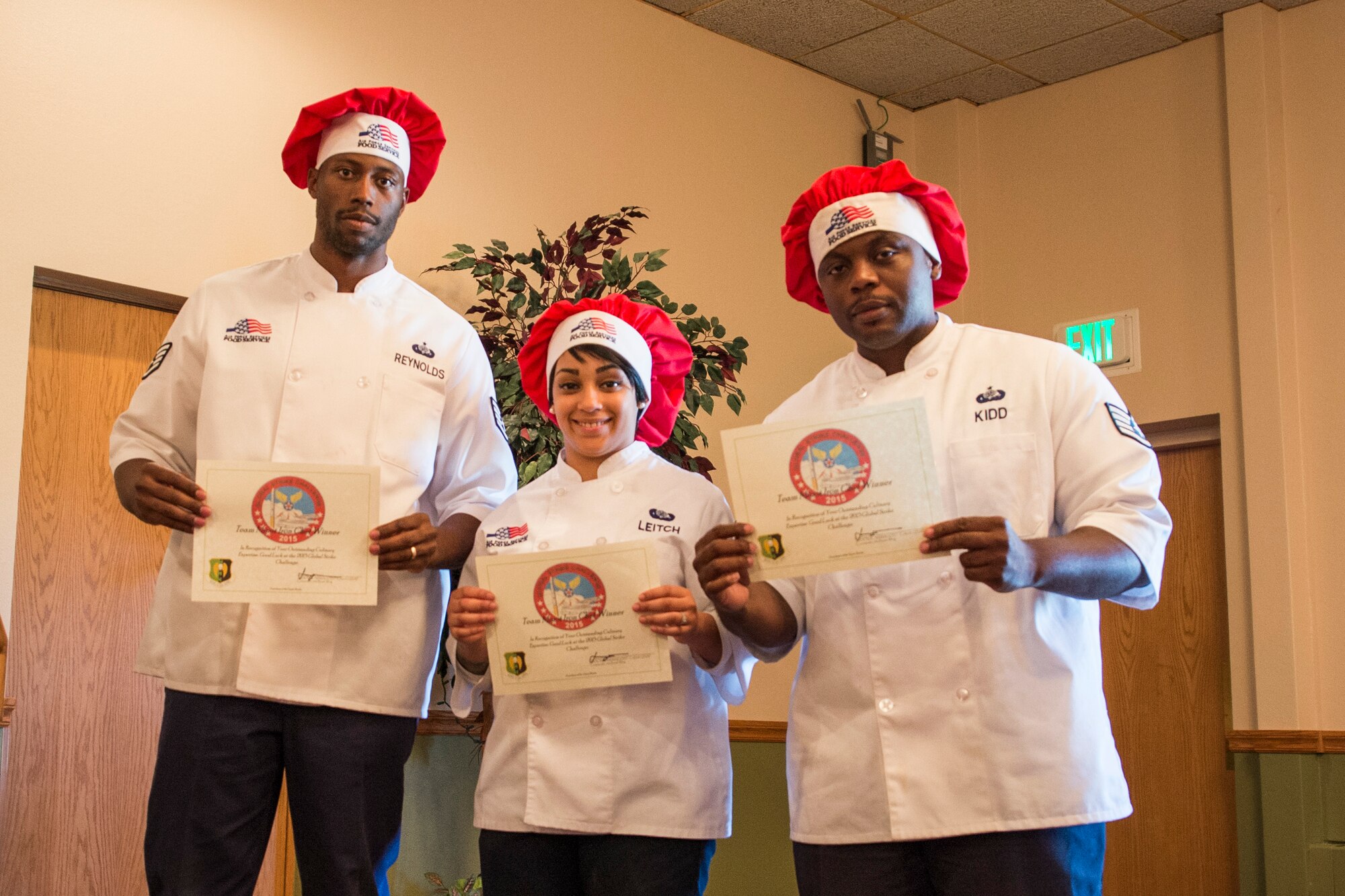 (Left) Winners of the first Iron Chef Global Strike Challenge competition, Staff Sgt. Jeremy Reynolds, 5th Force Support Squadron missile chef supervisor, Senior Airman Tanise Leitch, 5th FSS food service journeyman, and Staff Sgt. Ralaun Kidd, 5th FSS food service supervisor, pose with their certificates in the Jimmy Doolittle Center at Minot Air Force Base, N.D., Aug.10, 2015. The judges included: Col. Jason Armagost, 5th Bomb Wing commander; Col. Michael Lutton, 91st Missile Wing commander; Col. Kelvin Townsend, 91st MW vice commander; Col. Roy Collins, 5th Mission Support Group commander; and Chief Master Sgt. Dugger, 5th FSS superintendent. (U.S. Air Force photo/ Airman 1st Class Justin T. Armstrong)


