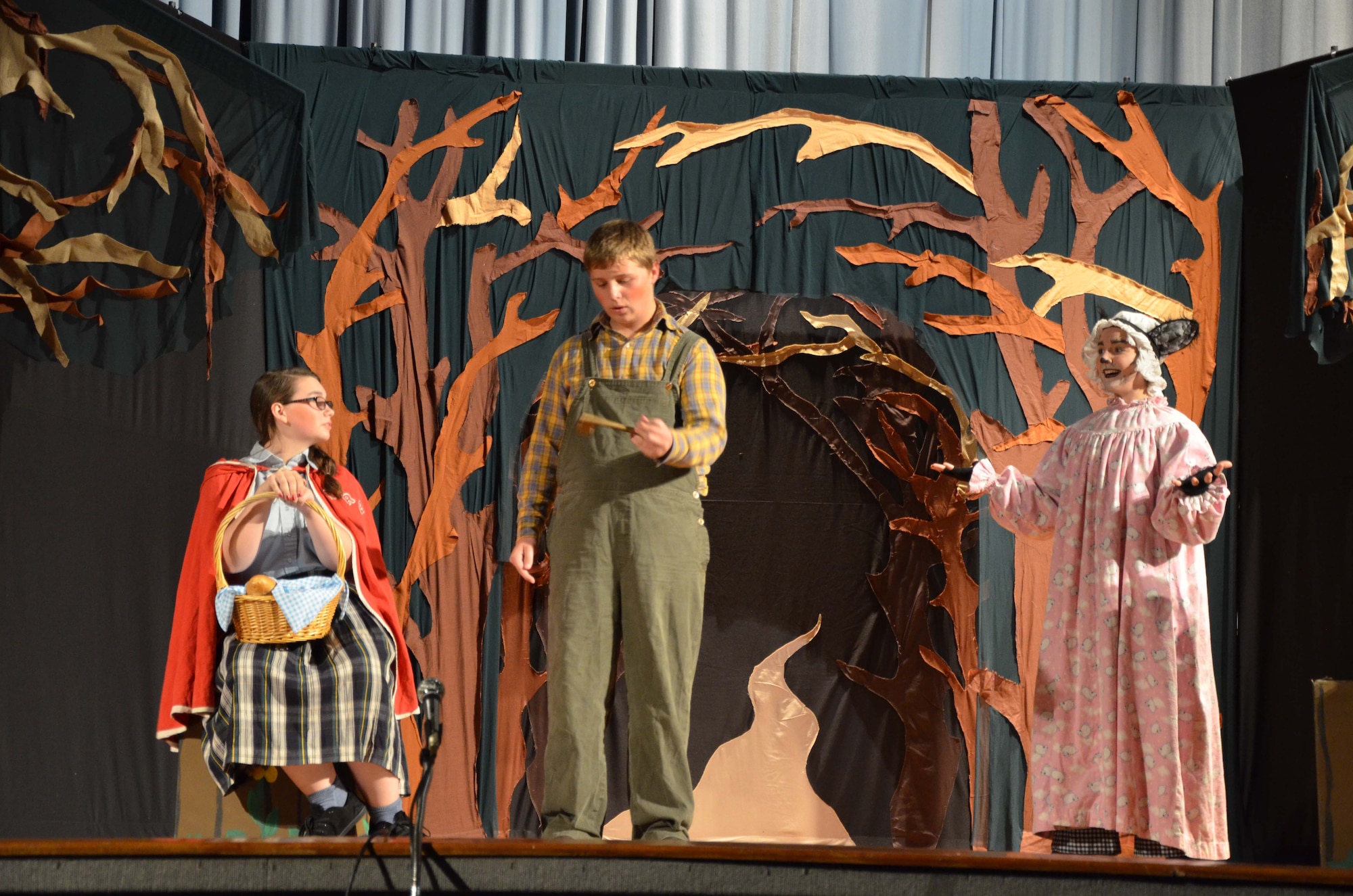 Hunter Plotkin (center), portraying a locksmith in the stage production of "Red Riding Hood," interacts with fellow Missoula Children's Theater child actor Alora Brown (left), who played Red Riding Hood in the show.  Joining the young thespians on stage is veteran MCT actor Lindsey Oetken, who portrayed the Big Bad Wolf. This is the 17th year the
Missoula traveling theater company came to Patrick AFB, Fla., to help children learn the basics of theater and boost morale.  (U.S. Air Force photo by Susan A. Romano)

