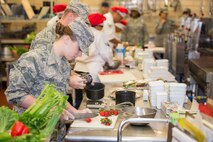 Airman 1st Class Stormie Geiger, 5th Force Support Squadron missile chef, cuts strawberries during the first Iron Chef Global Strike Challenge competition in the Jimmy Doolittle Center at Minot Air Force Base, N.D., Aug. 10, 2015. Three teams of three chefs from 5th FSS had one hour to complete their meals for the judges. (U.S. Air Force photo/ Airman 1st Class Justin T. Armstrong)

