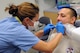 U.S. Air Force Maj. Jessica Bramlette, left, prepares Senior Airman Victor Petrelli for a dental X-ray at the dental clinic on Spangdahlem Air Base, Germany, Aug. 12, 2015. Bramlette and Petrelli are both members of the New Jersey Air National Guard's 177th Medical Group deployed to Spangdahlem for training. (U.S. Air National Guard photo by Senior Airman Shane S. Karp/Released) 