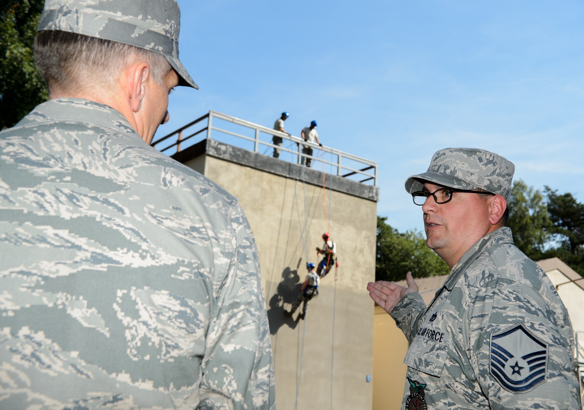 Master Sgt. Max Wheeler, 435th Construction and Training Squadron Emergency Management Services Contingency Training section chief, explains the climbing procedure being shown to Lt. Gen. Timothy M. Ray, 3rd Air Force commander, Aug. 6, 2015, at Ramstein Air Base, Germany. Ray recently took command of the 3rd Air Force and visited 435th CTS to understand how they operate and view their capabilities. (U.S. Air Force photo/ Staff Sgt. Armando A. Schwier-Morales)
