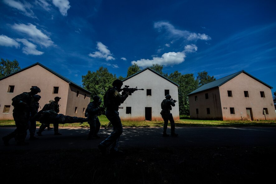 Airmen move a simulated gunshot wound patient through a training range Aug. 5, 2015, on Baumholder, Germany.  More than 20 Airmen from the 435th Contingency Response Support Squadron, 435th Security Forces Squadron and the 86th Medical Group participated in the bi-annual Tactical Combat Casualty Care course Aug 3 through 6. (U.S. Air Force photo/Senior Airman Nicole Sikorski)