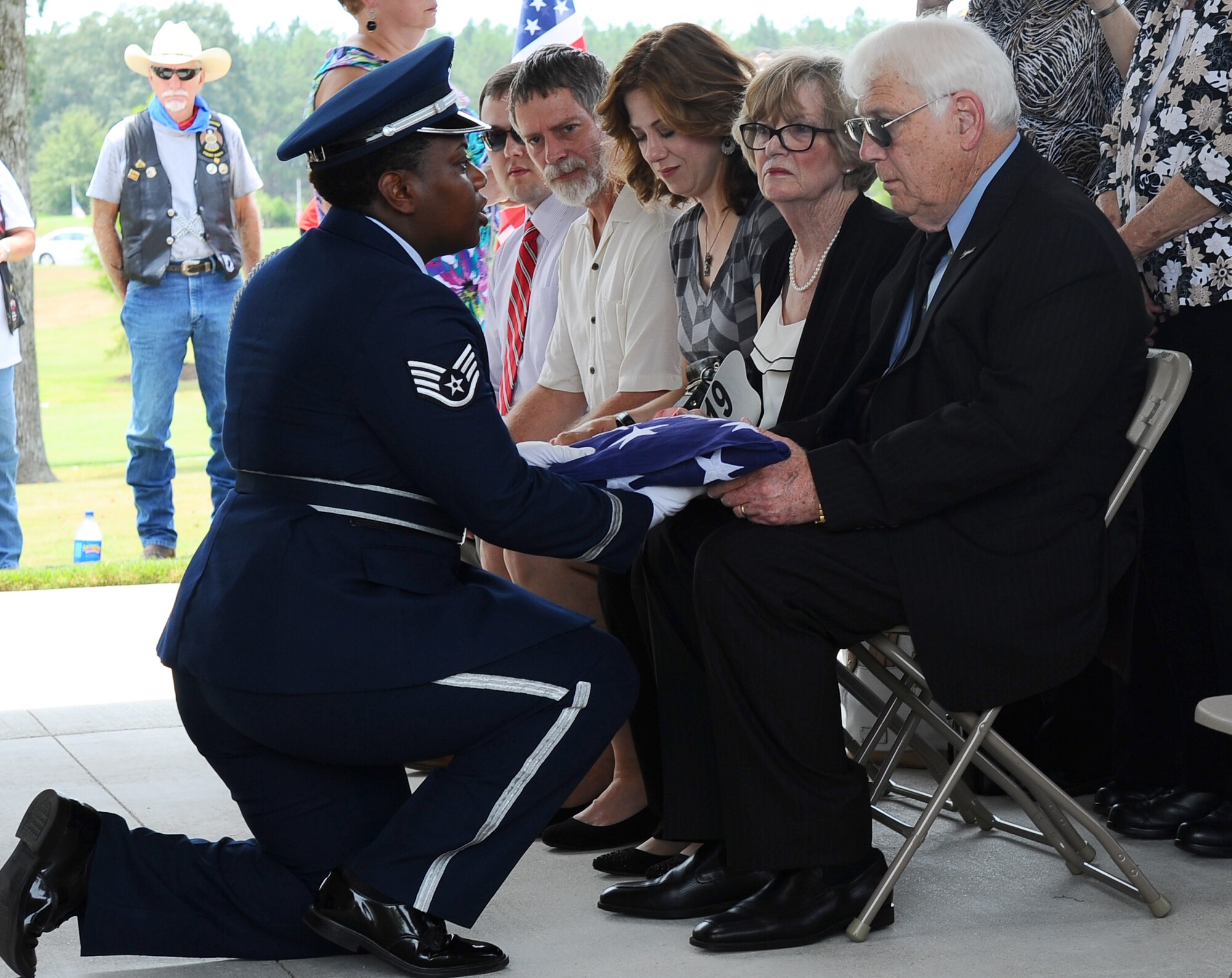 Staff Sgt. Sherring Goodwin, Columbus Air Force Base Honor guardsman, presents the folded American flag to Joe Partridge, brother of the late Capt. Frederick Partridge, Aug. 10 at the Mississippi Veterans Memorial Cemetery. Full honors were presented by the Honor Guardsmen for Partridge to include a flag folding, firing party, color team and a bugle player who finished the ceremony with the playing of Taps. (U.S. Air Force photo/Senior Airman Kaleb Snay)