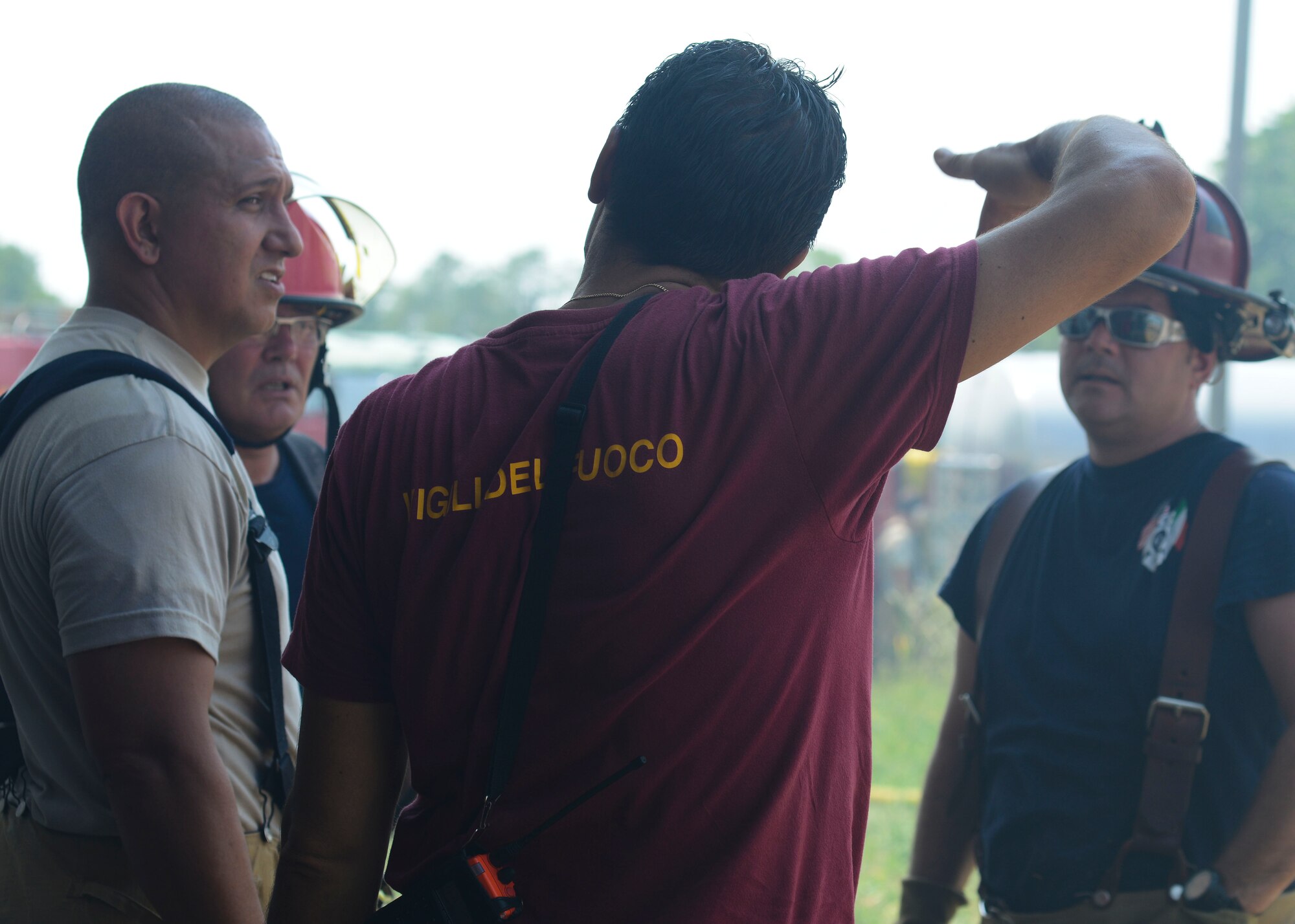 U.S. Air Force firefighters speak with a Pordenone Vigile del Fuoco, Aug. 11, 2015, near Marsure, Italy. At the request of local Italian authorities, Aviano Air Base personnel responded to the off-base fire due to their proximity to Marsure. (U.S. Air Force photo by Senior Airman Austin Harvill/Released)