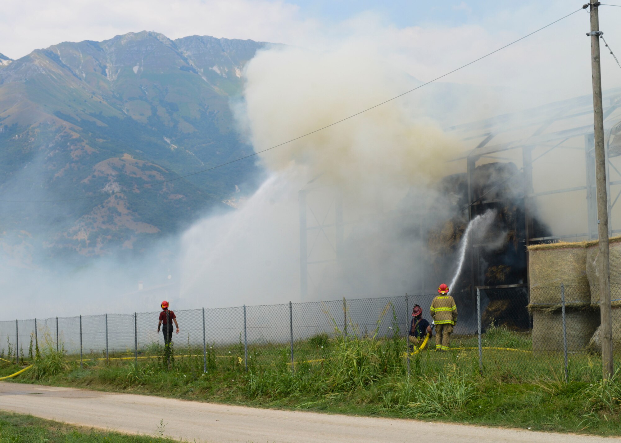 U.S. Air Force firefighters and Pordenone Vigili del Fuoco battle a hay barn fire, Aug. 11, 2015, near Marsure, Italy. At the request of local Italian authorities, Aviano Air Base personnel responded to the off-base fire due to their proximity to Marsure. (U.S. Air Force photo by Senior Airman Austin Harvill/Released)