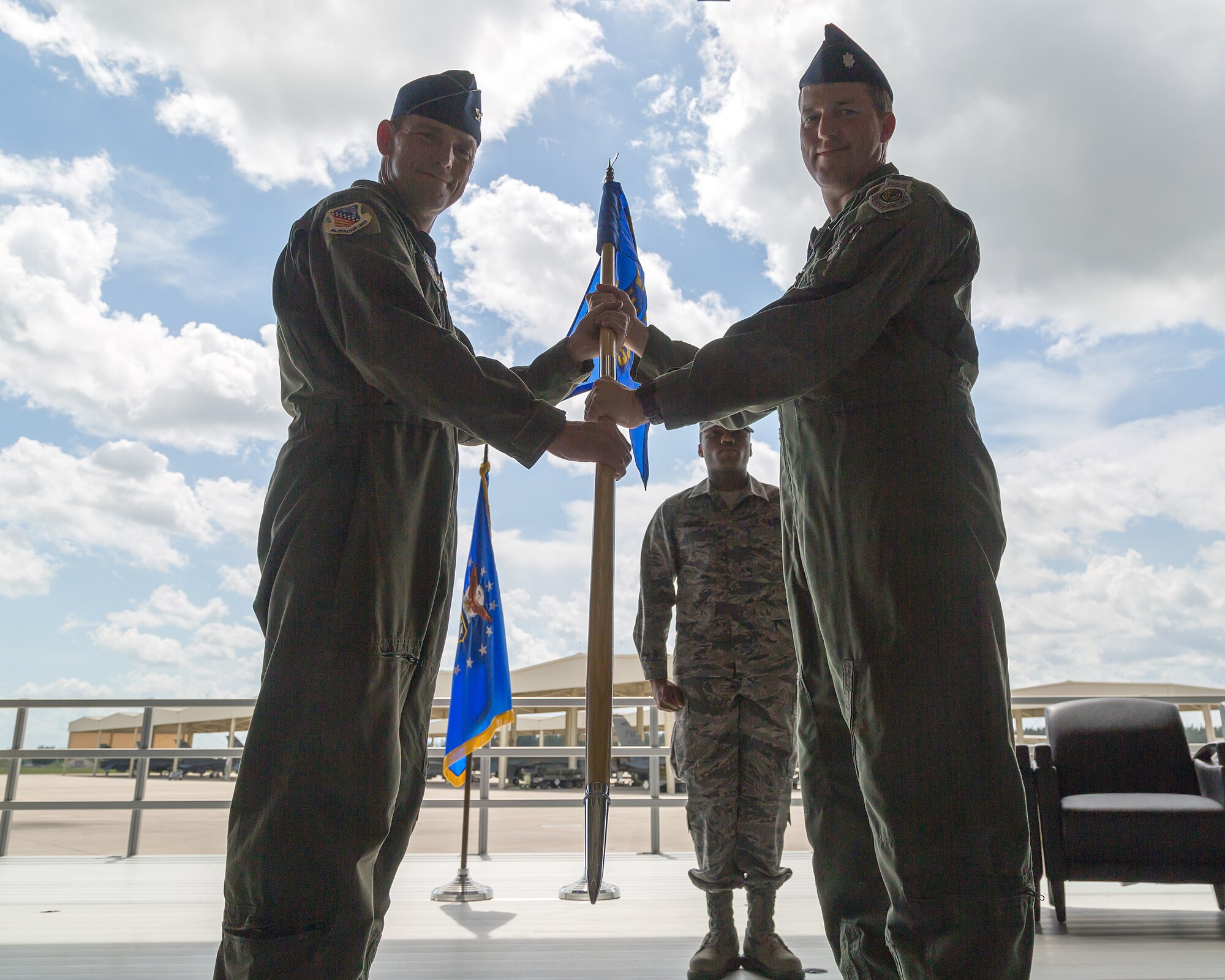 Col. David W. Smith, 482nd Operations Group commander, hands the 93rd Fighter Squadron guidon to incoming 93rd FS commander Lt. Col. Mark D. Van Brunt. The 93rd FS "Makos" held a change of command ceremony Aug. 9 during the August Unit Training Assembly. Lt. Col. Timothy D. Rusch relinquished command to Van Brunt. (U.S. Air Force photo/Tech. Sgt. Lionel Castellano)
