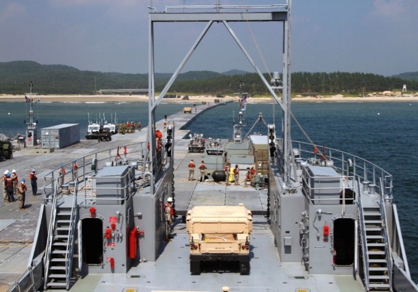U.S. Army Soldiers from the 7th Transportation Brigade (Expeditionary), 10th Transportation Battalion, build a modular causeway system on a beach in South Korea. The Joint Base Langley-Eustis Soldiers built the causeway as part of a combined logistics over-the-shore exercise that began May 11, 2015. (U.S. Army courtesy photo)