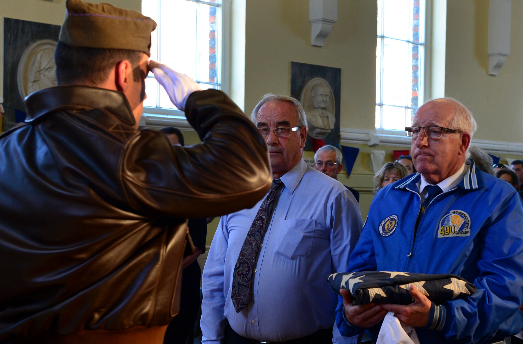 Tech. Sgt. Jamie Sherwood, 48th Component Maintenance Squadron aerospace propulsion craftsman, renders a salute during a remembrance ceremony in Eye, England, Aug. 9, 2015. Sherwood presented the retired U.S. flag to Eye historian, Eric Swain. U.S. Airmen gathered in Eye, along with local citizens, to commemorate the contributions of the 490th BG, who flew out of Royal Air Force Eye during World War II. (U.S. Air Force photo by Senior Airman Dawn M. Weber/Released)