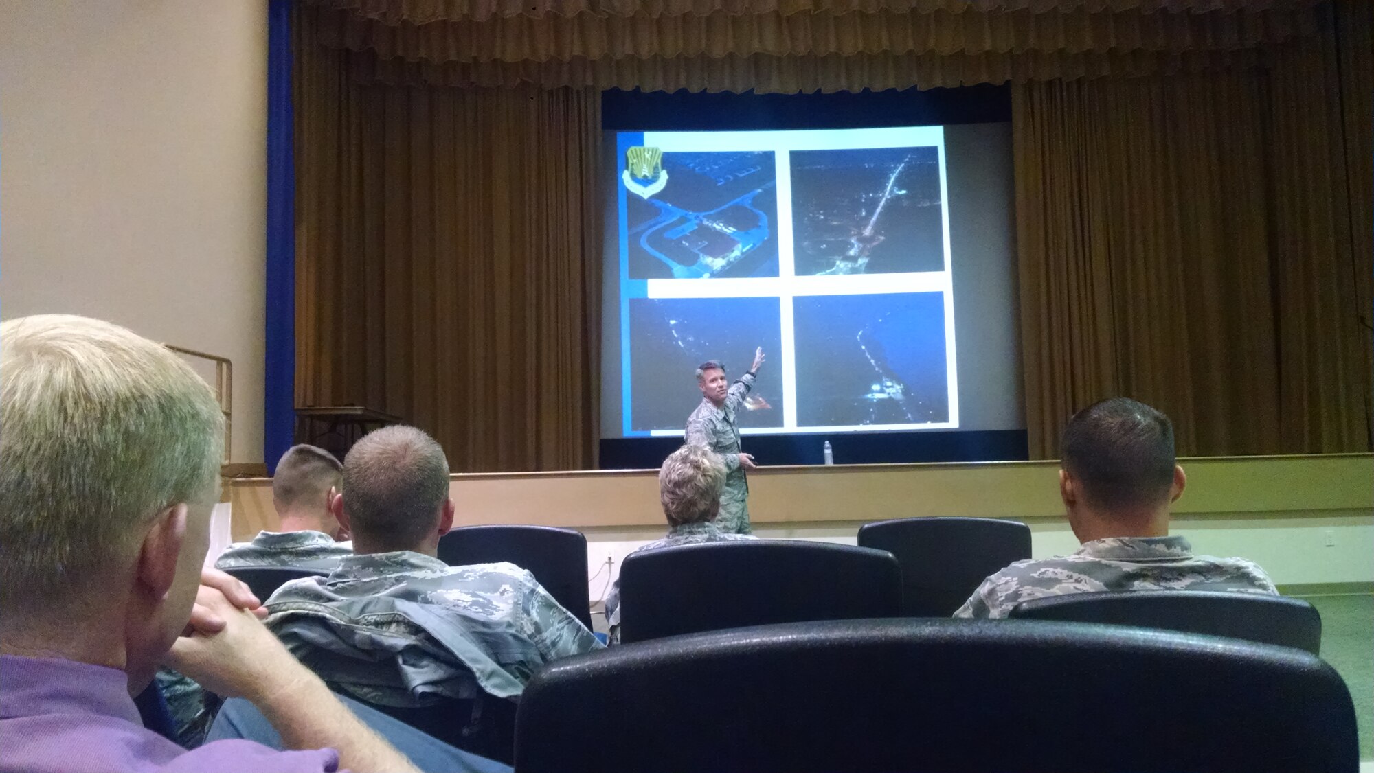 Col. Daniel Tulley, 6th Air Mobility Wing commander, briefs during a town hall at MacDill Air Force Base, Aug. 3. Various speakers were utilized to provide different perspectives and a wide range of knowledge on the gate issue and what was being done to fix it. (Courtesy Photo)