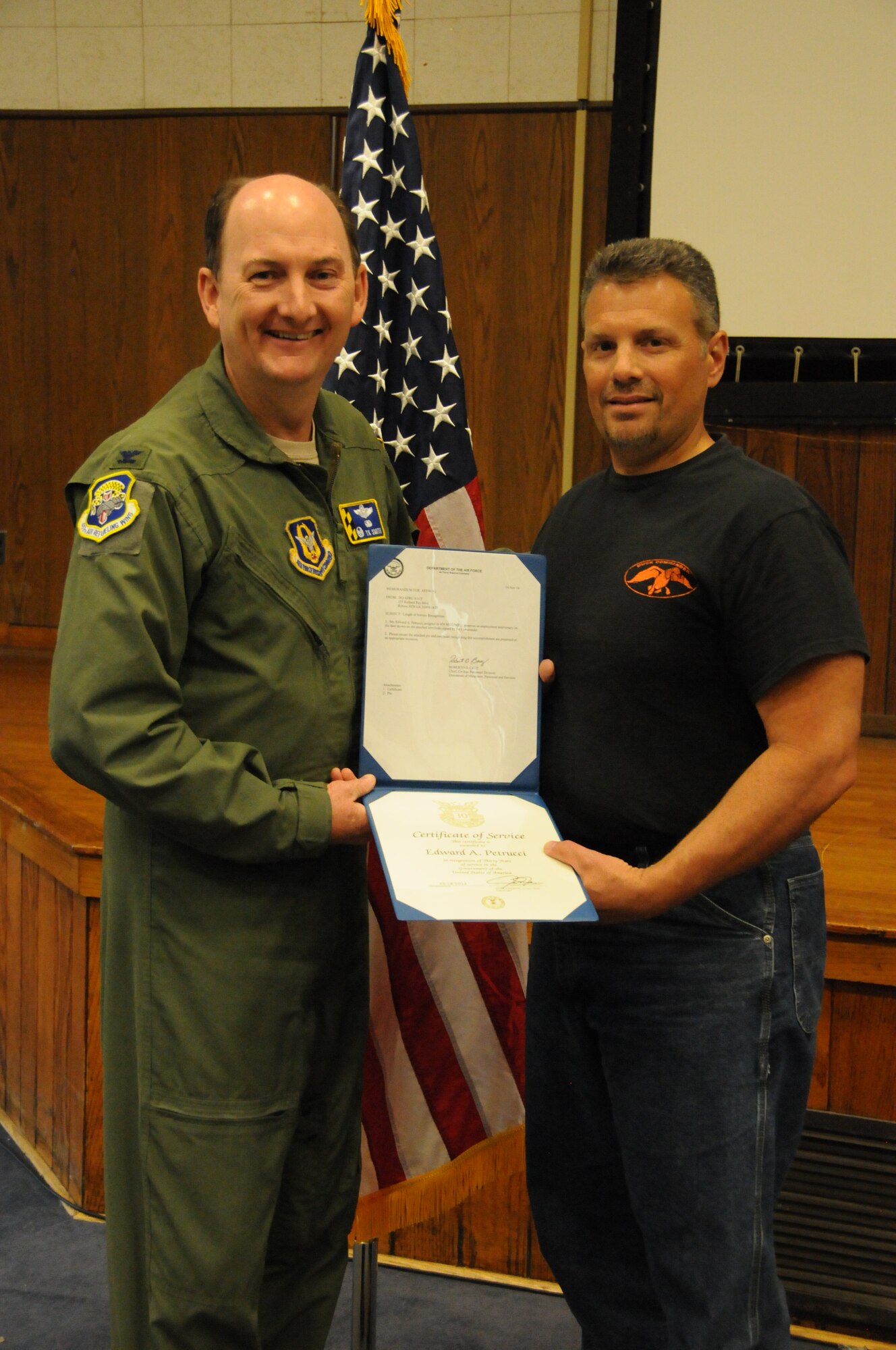 Mr. Edward Petrucci is awarded a certificate to honor his more than 30 years of service as a civilian.