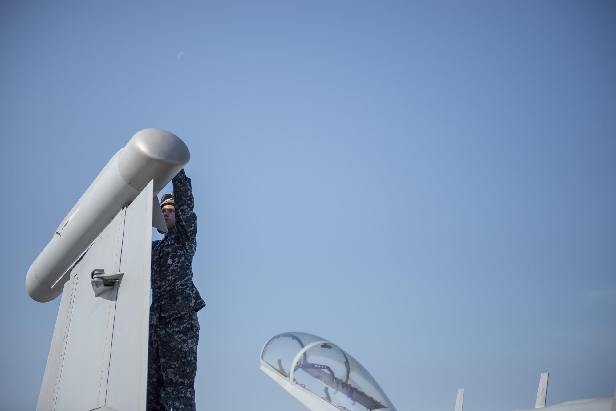 U.S. Navy Airman Monty Lowden, a plane captain assigned to Electronic Attack Squadron 209, Naval Air Station Whidbey Island, Wash., inspects an EA-18G Growler electronic warfare aircraft, Aug. 7, 2015, following a RED FLAG-Alaska (RF-A) 15-3 sortie to ensure the jet maintains operational readiness at Eielson Air Force Base, Alaska. RF-A is a Pacific Air Forces commander-directed field training exercise for U.S. and partner nation forces, providing combined offensive counter-air, interdiction, close air support and large force employment training in a simulated combat environment. (U.S. Air Force photo by 1Lt Elias Zani/Released)