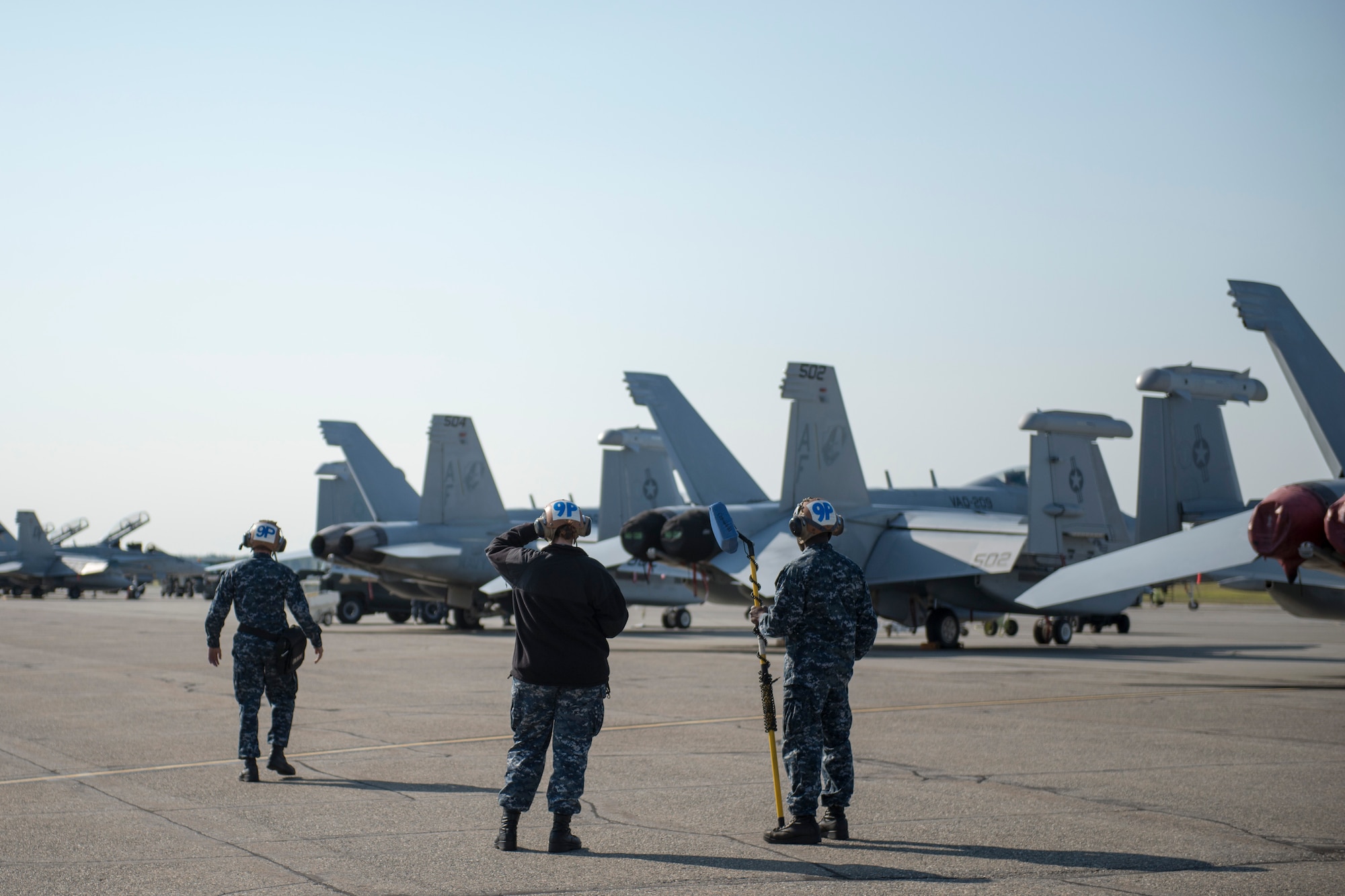 U.S. Navy maintainers assigned to Electronic Attack Squadron 209, Naval Air Station Whidbey Island, Wash., prepare to recover an EA-18G Growler electronic warfare aircraft following a RED FLAG-Alaska (RF-A) 15-3 sortie, Aug. 7, 2015, Eielson Air Force Base, Alaska. RF-A is a Pacific Air Forces commander-directed field training exercise for U.S. and partner nation forces, providing combined offensive counter-air, interdiction, close air support and large force employment training in a simulated combat environment. (U.S. Air Force photo by 1Lt Elias Zani/Released)