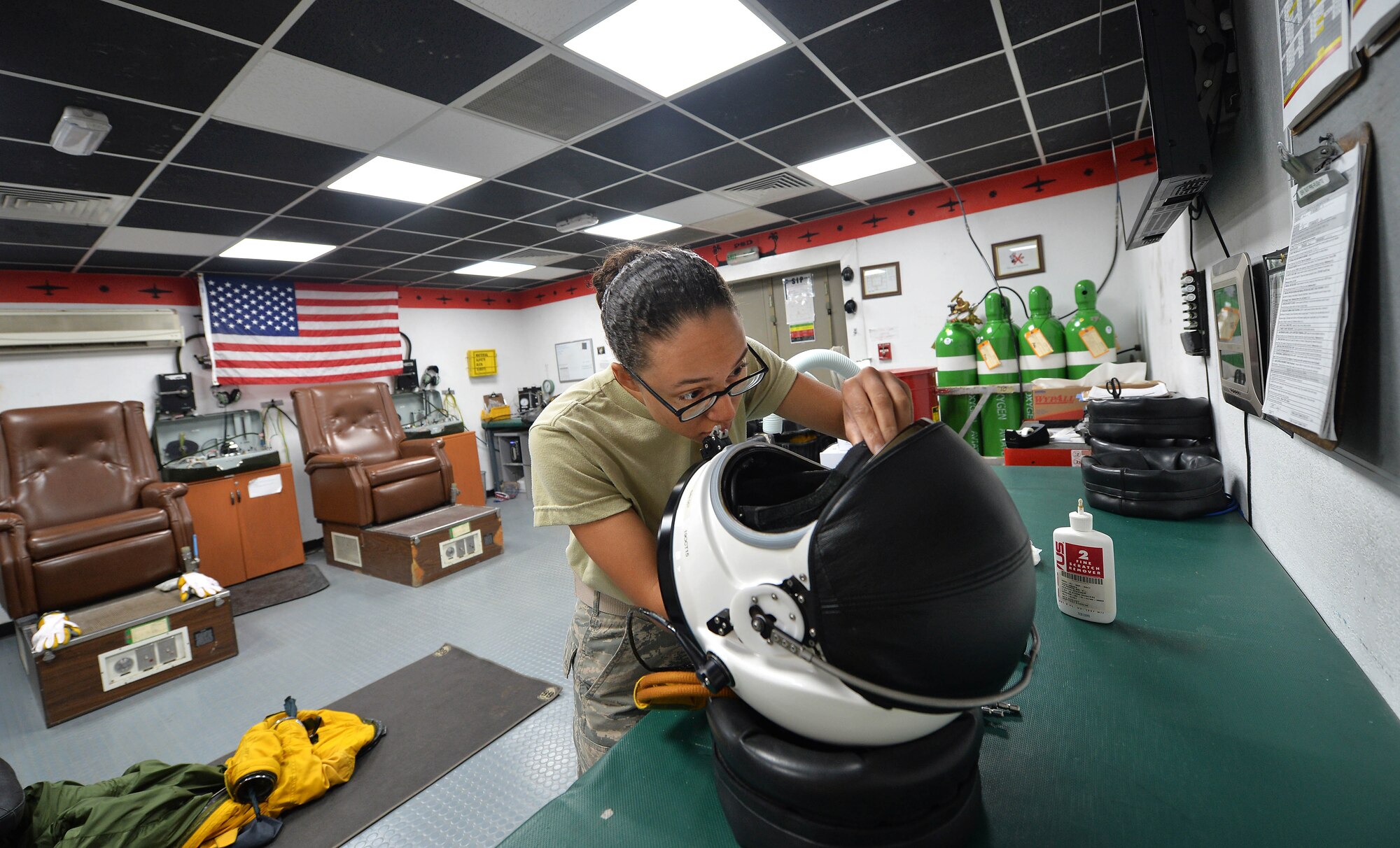 Airman First Class Christian, Expeditionary Reconnaissance Squadron physiology support technician, prepares a full pressure suit helmet at an undisclosed location in Southwest Asia Aug. 7, 2015. U-2 pilots are required to wear the specialized suit due to the high altitudes they typically fly at. The physiological support detachment team is responsible for maintaining the suit, ensuring it functions properly and assisting pilots with donning the gear. (U.S. Air Force photo/Tech. Sgt. Jeff Andrejcik)