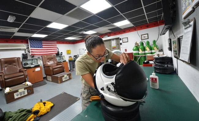 Airman 1st Class Christian, an expeditionary reconnaissance squadron physiology support technician, prepares a full-pressure suit helmet at an undisclosed location in Southwest Asia, Aug. 7, 2015. U-2S pilots are required to wear the specialized suit due to the high altitudes they typically fly at. The physiological support detachment team is responsible for maintaining the suit, ensuring it functions properly and assisting pilots with donning the gear. (U.S. Air Force photo/Tech. Sgt. Jeff Andrejcik)