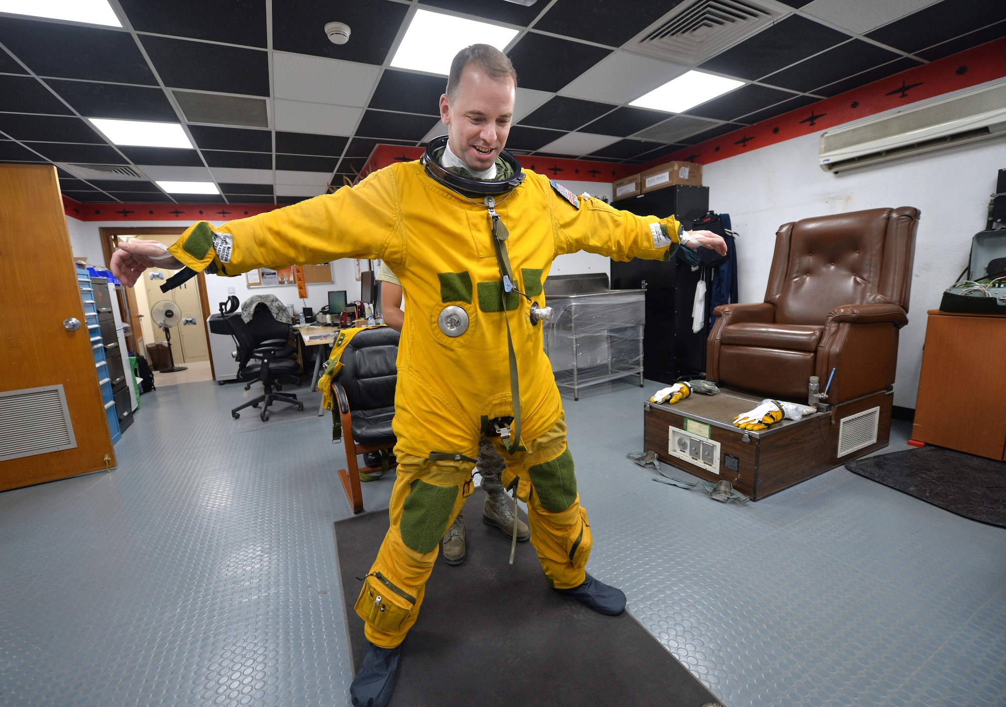 Lt. Col. David, Expeditionary Reconnaissance Squadron U-2 pilot, puts on a full pressure suit at an undisclosed location in Southwest Asia Aug. 7, 2015. U-2 pilots are required to wear the specialized suit due to the high altitudes, typically above 70,000 feet, they fly at. The physiological support detachment team is responsible for maintaining the suit, ensuring it functions properly and assisting pilots with donning the gear. (U.S. Air Force photo/Tech. Sgt. Jeff Andrejcik)