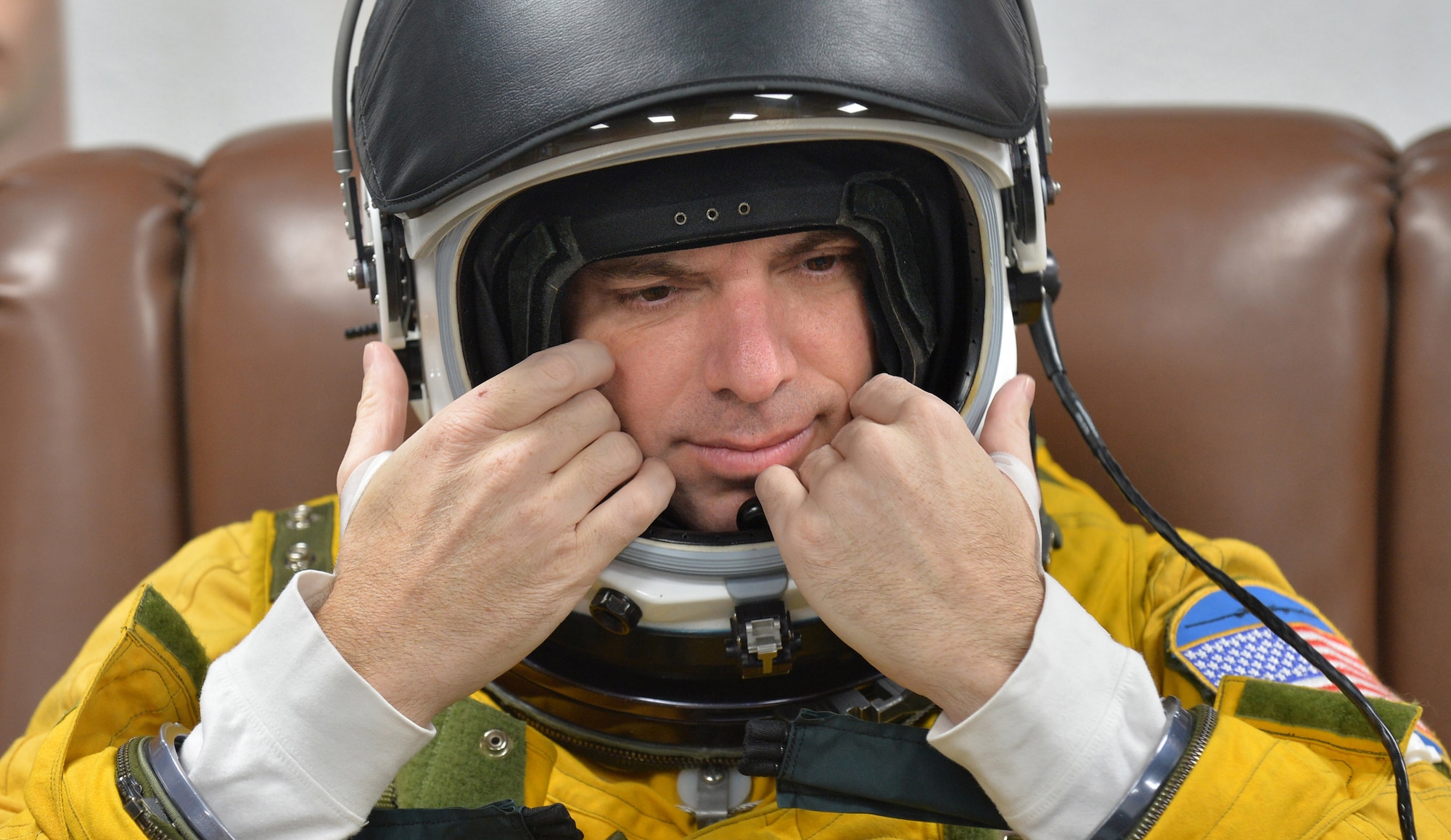 Lt. Col. David, Expeditionary Reconnaissance Squadron U-2 pilot, adjusts his full pressure suit helmet at an undisclosed location in Southwest Asia Aug. 7, 2015. U-2 pilots are required to wear the specialized suit due to the high altitudes, typically above 70,000 feet, they fly at. The physiological support detachment team is responsible for maintaining the suit, ensuring it functions properly and assisting pilots with donning the gear. (U.S. Air Force photo/Tech. Sgt. Jeff Andrejcik)