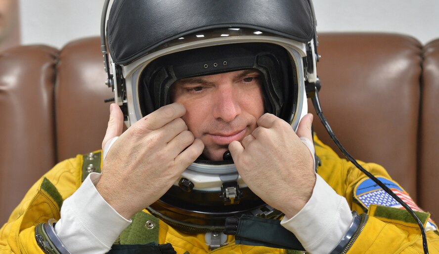 Lt. Col. David, an expeditionary reconnaissance squadron U-2S pilot, adjusts his full-pressure suit helmet at an undisclosed location in Southwest Asia, Aug. 7, 2015. U-2 pilots are required to wear the specialized suit due to the high altitudes they fly at, typically above 70,000 feet. The physiological support detachment team is responsible for maintaining the suit, ensuring it functions properly and assisting pilots with donning the gear. (U.S. Air Force photo/Tech. Sgt. Jeff Andrejcik)